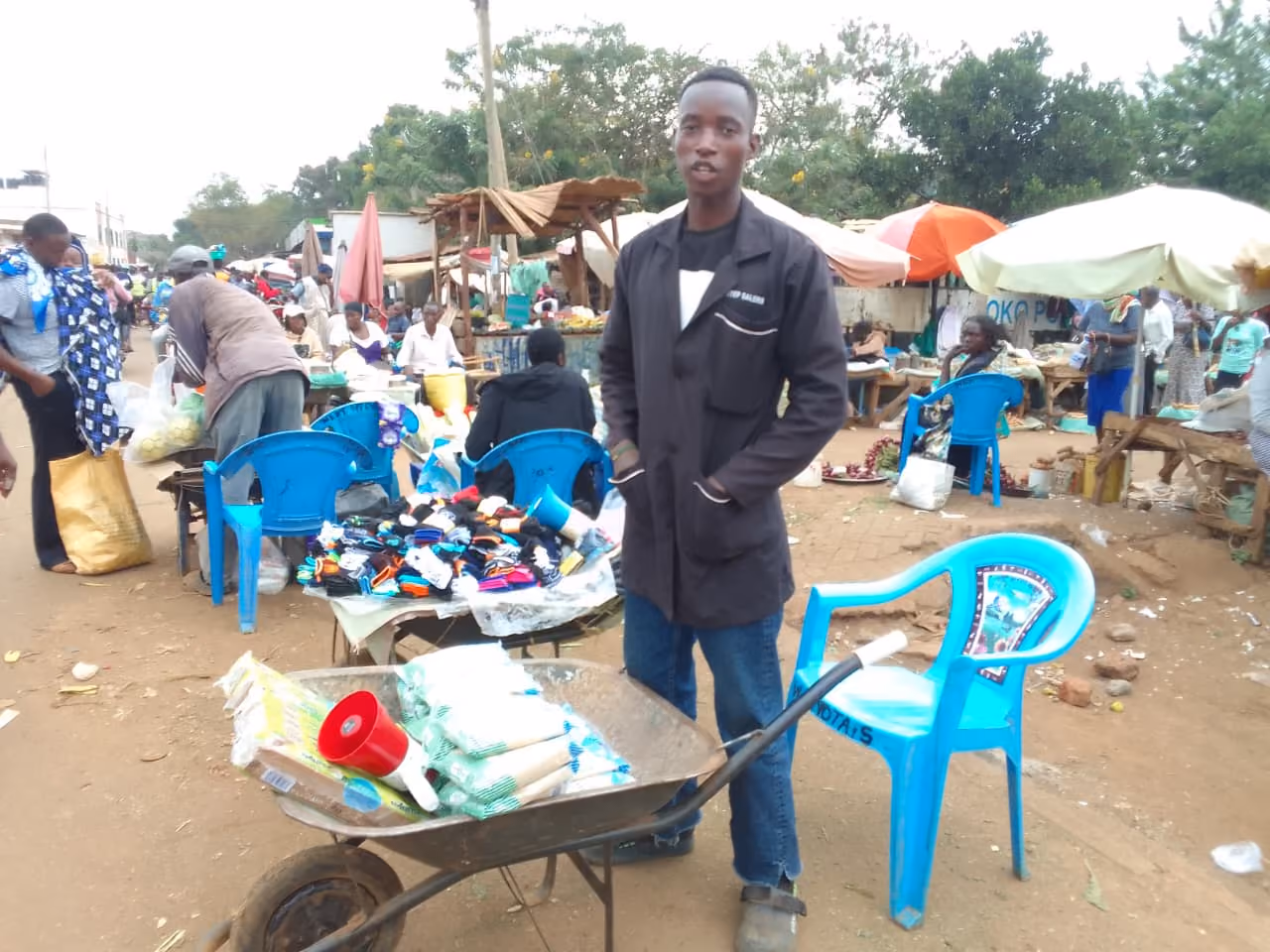 A young entrepreneur working with market goods as part of the Youth Productivity Network.