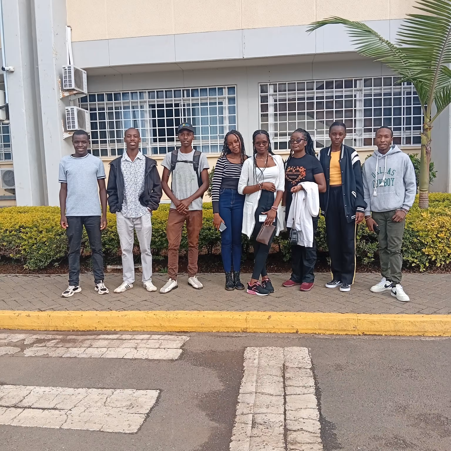 AYCP participants gathered outside an institutional building in Kenya.